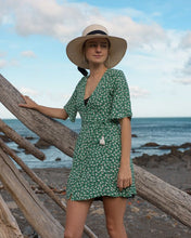 young woman wearing a wide brim Panama hat at the beach